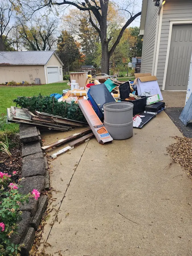 Dumpster being loaded with debris for 10 Yard Dumpster Rental in Kennett